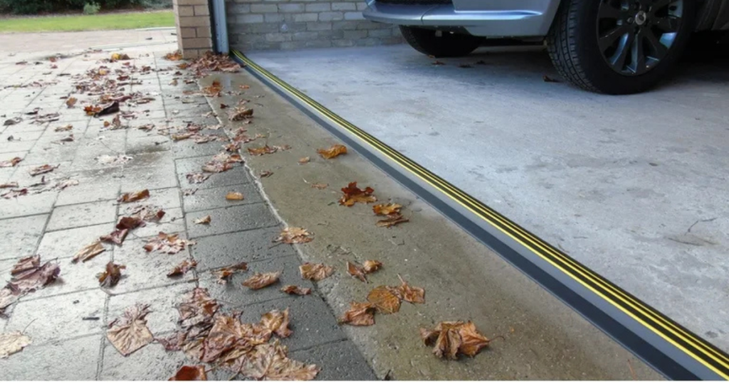 Garage floor seal blocks water and leaves.