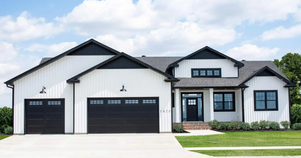 white house with black garage doors